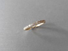 0.32ct diamond band ring set in 9ct yellow gold. Small brilliant cut diamonds, I colour and i1