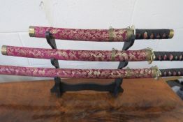 Set Of Ornamental Decorative Swords On Display Stand
