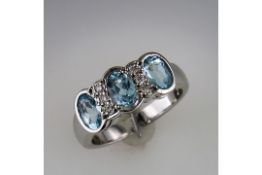 An Unused 3 Stone Aquamarine and Diamond Ring