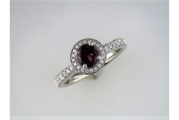 An Unused Diamond and Rhodolite Halo Ring