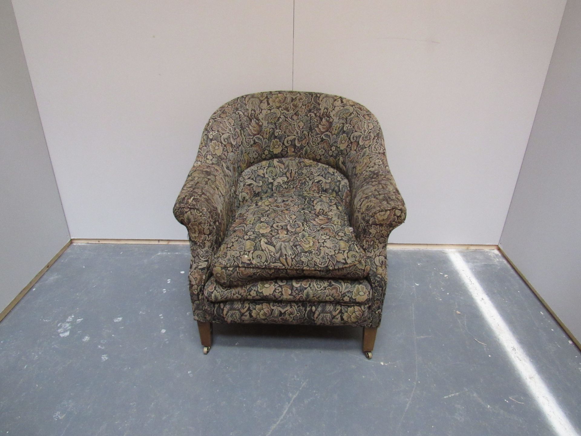 Small tub chair raised on square tapering legs covered in a funky covering