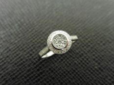 0.33ct diamond set solitaire style ring set in 9ct white gold. Halo setting with Illusion set