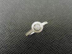 0.26ct diamond set solitaire style ring set in 9ct white gold. Halo setting with Illusion set
