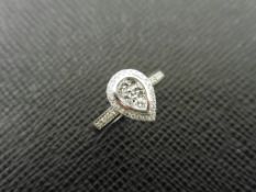 0.33ct diamond set solitaire style ring. Pear shape setting with small round cut diamonds, H