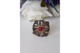 AGI Certified. A Unique Diamond & Ruby Ring, 52 Diamonds & Single centre Cabochon Ruby.