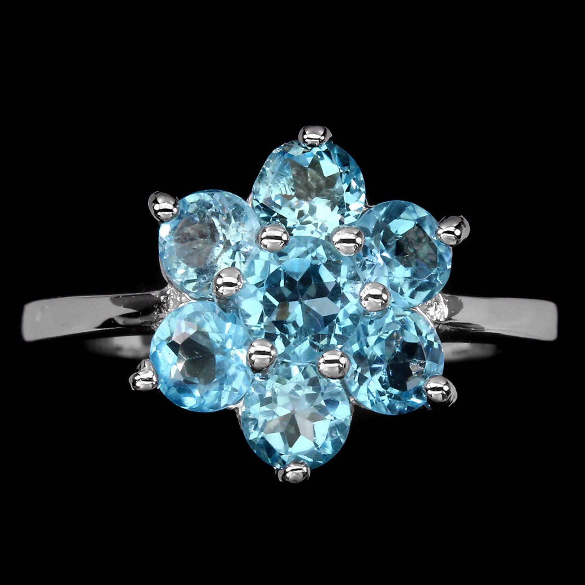 A Beautiful Natural Swiss Blue Topaz Ring, set with 7 Round cut African Blue Topaz - Size M.