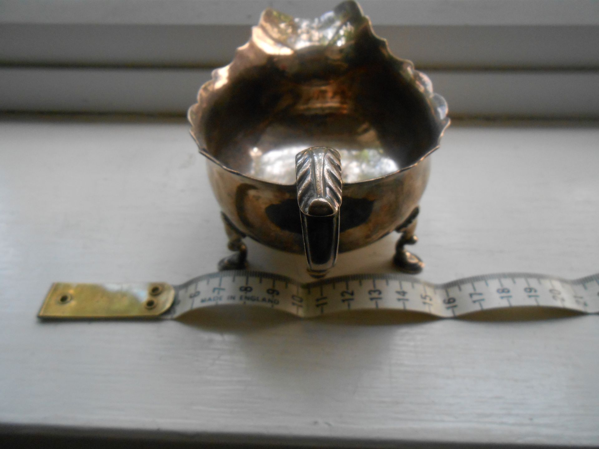 A hallmarked solid Silver George III sauce boat on three feet - Image 4 of 6