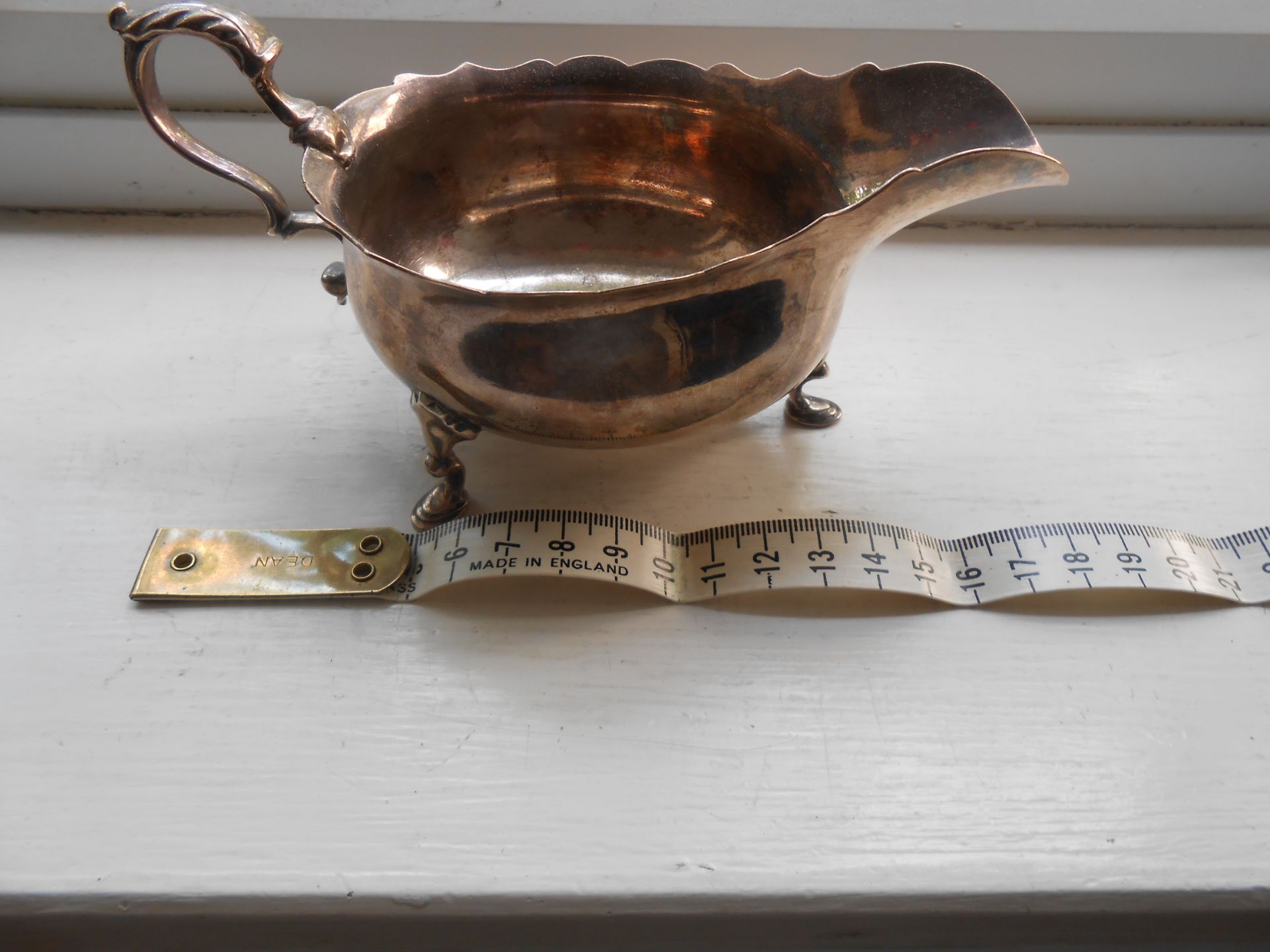 A hallmarked solid Silver George III sauce boat on three feet - Image 2 of 6