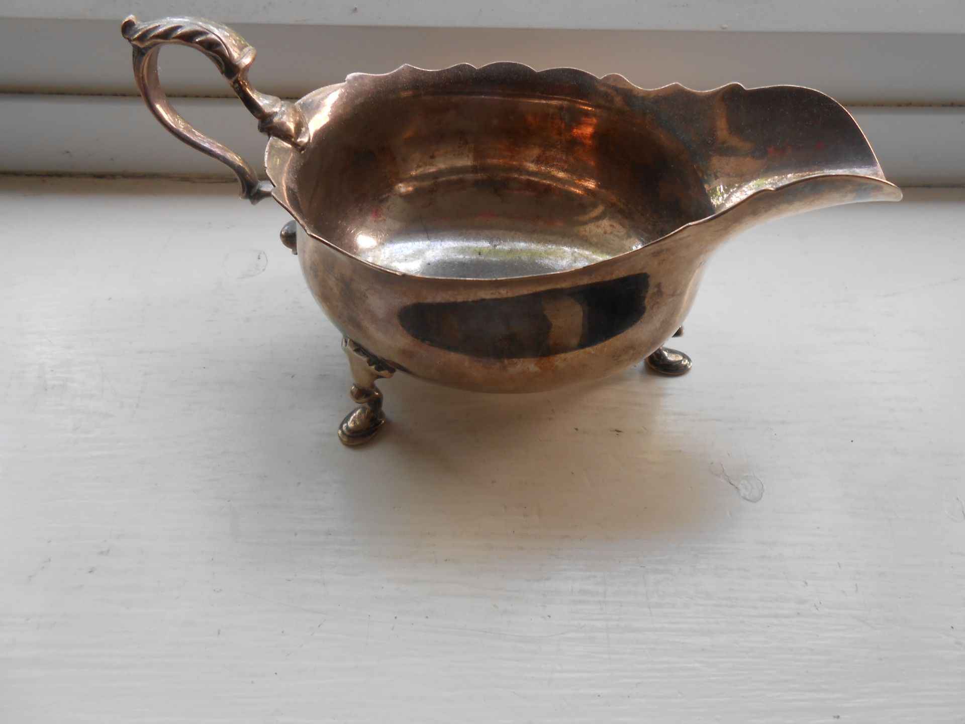 A hallmarked solid Silver George III sauce boat on three feet