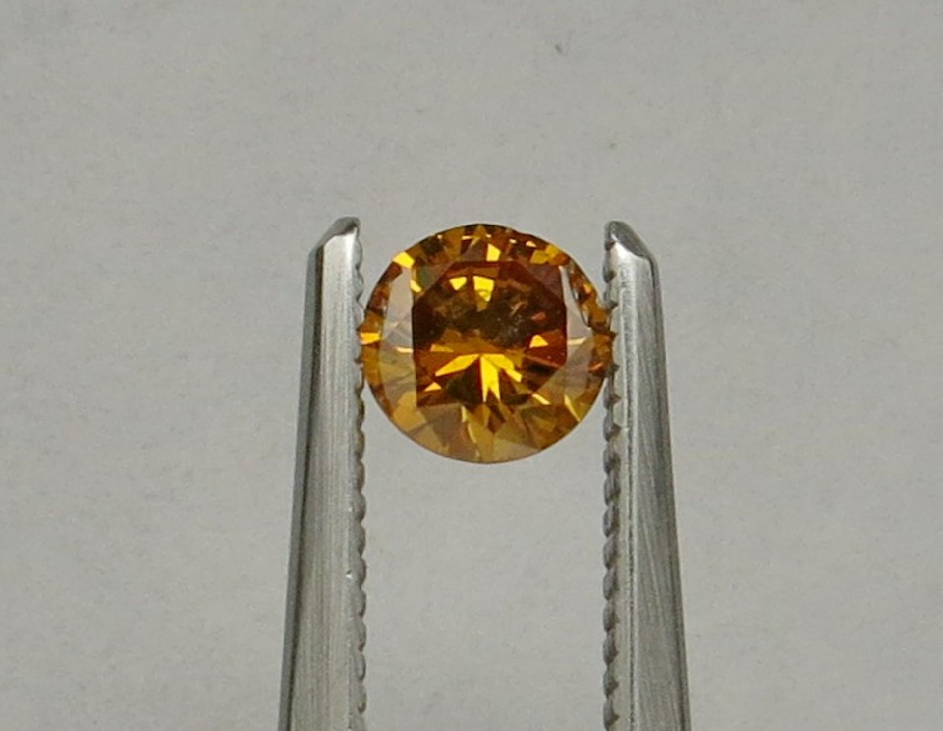 An unmounted Round-shaped diamond weighing app. 0.35ct. Colour : Orange Yellow .Clarity :I1