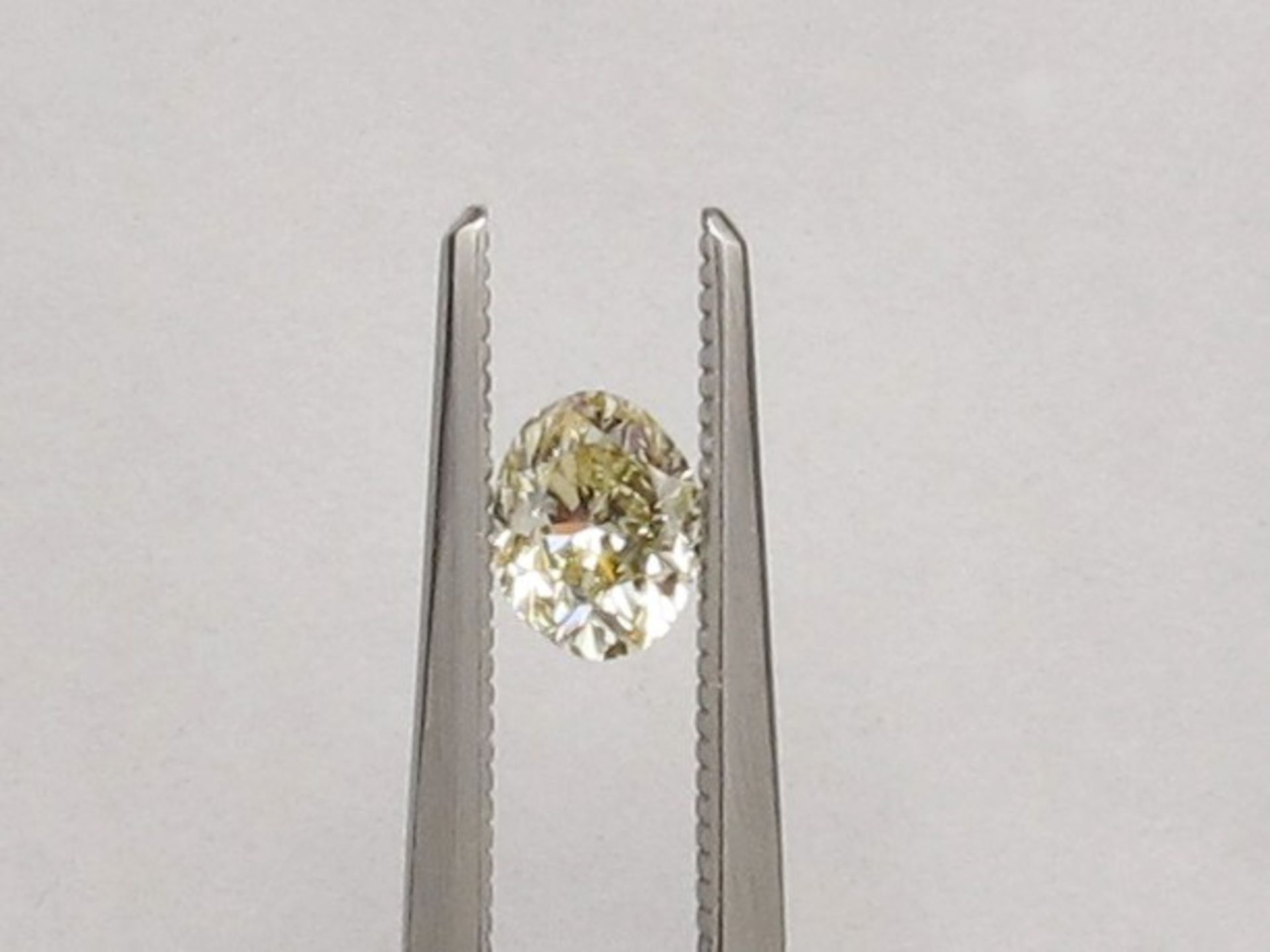 An unmounted Oval-shaped diamond weighing app. 0.68ct. Colour : Yellow .Clarity :SI2