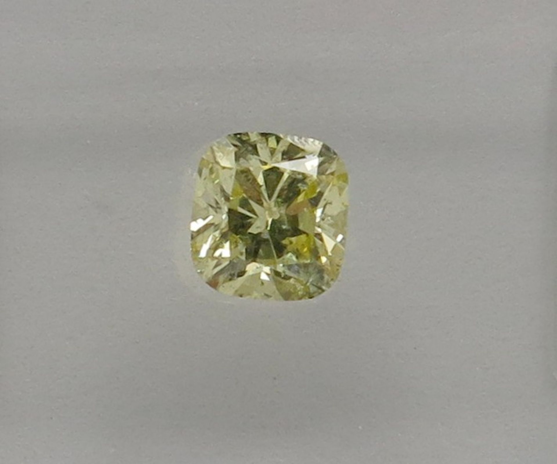An unmounted Cushion-shaped diamond weighing app. 0.59ct. Colour : Yellow .Clarity :I1