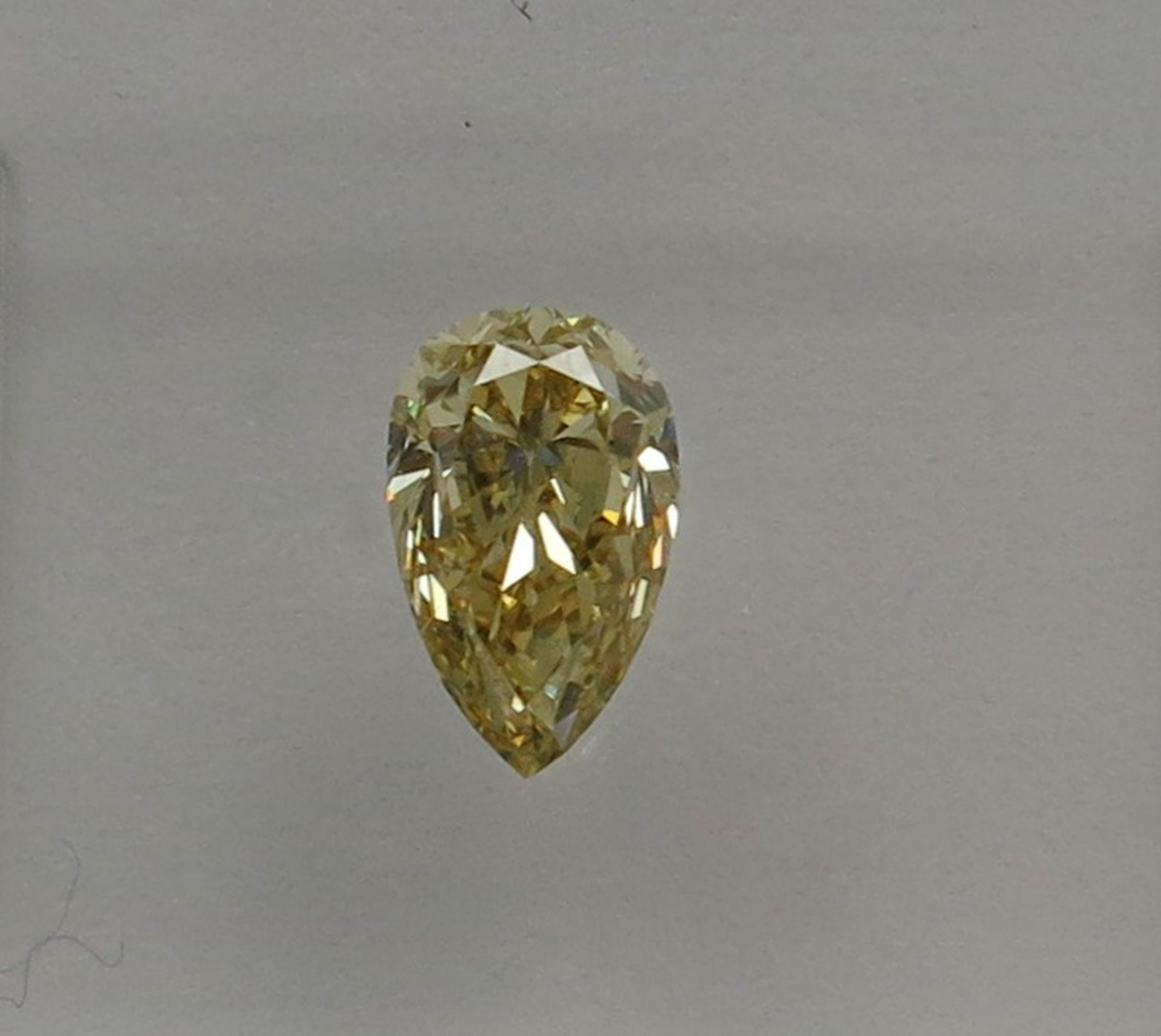 An unmounted Pear-shaped diamond weighing app. 0.52ct. Colour : Yellow .Clarity :VVS2