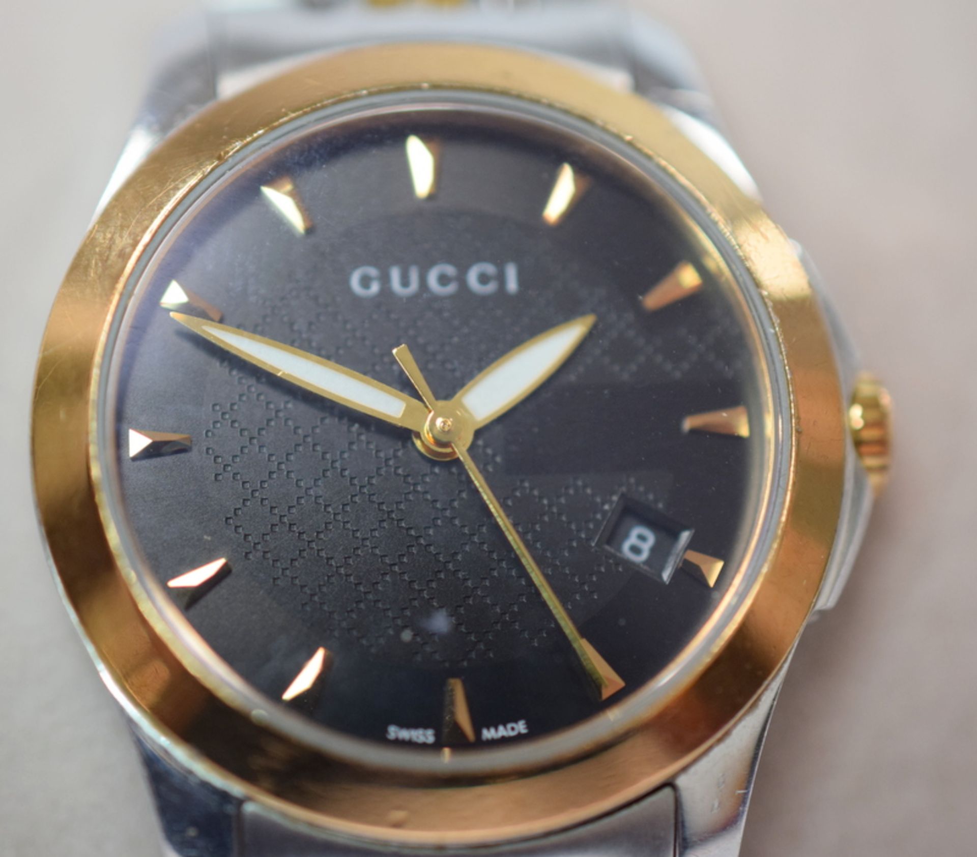 Lady's Gucci G-Timeless watch.