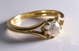 A stunning engagement ring consisting of an old cut diamond set in an ornate gold setting.