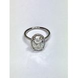 3.01ct diamond set solitaire ring. Oval cut diamond H colour si2 clarity in the centre with a halo
