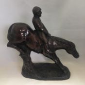 Signed vintage moulded resin equestrian figurine of a jumping horse and jockey