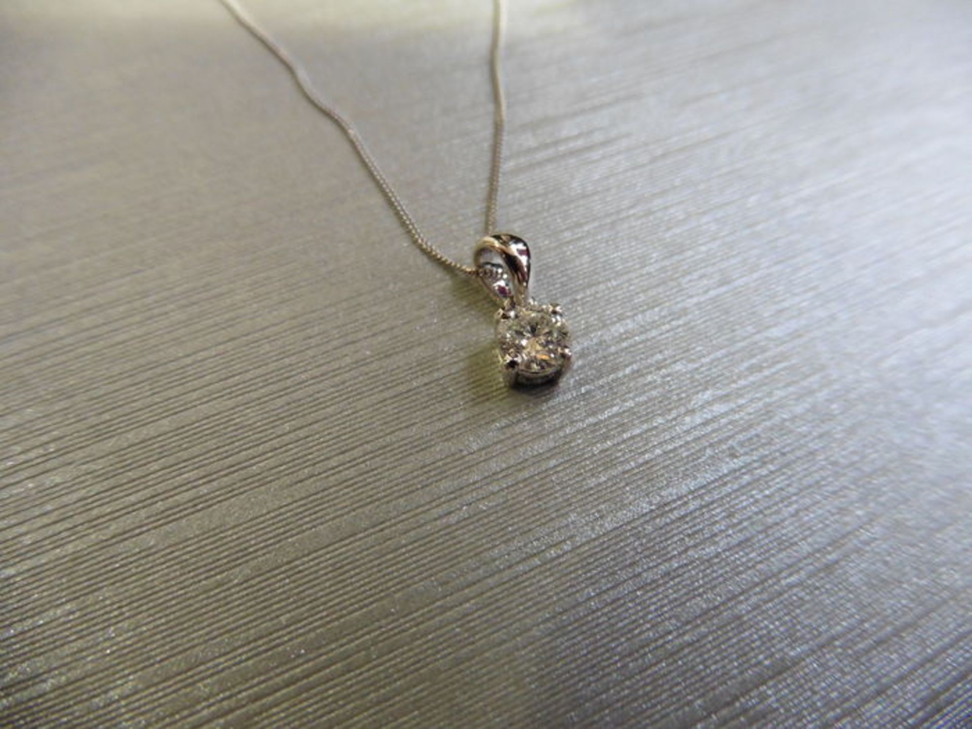 0.15ct diamond solitaire pendant set in 18ct gold. 4 claw setting, plain bale. I colour and si3