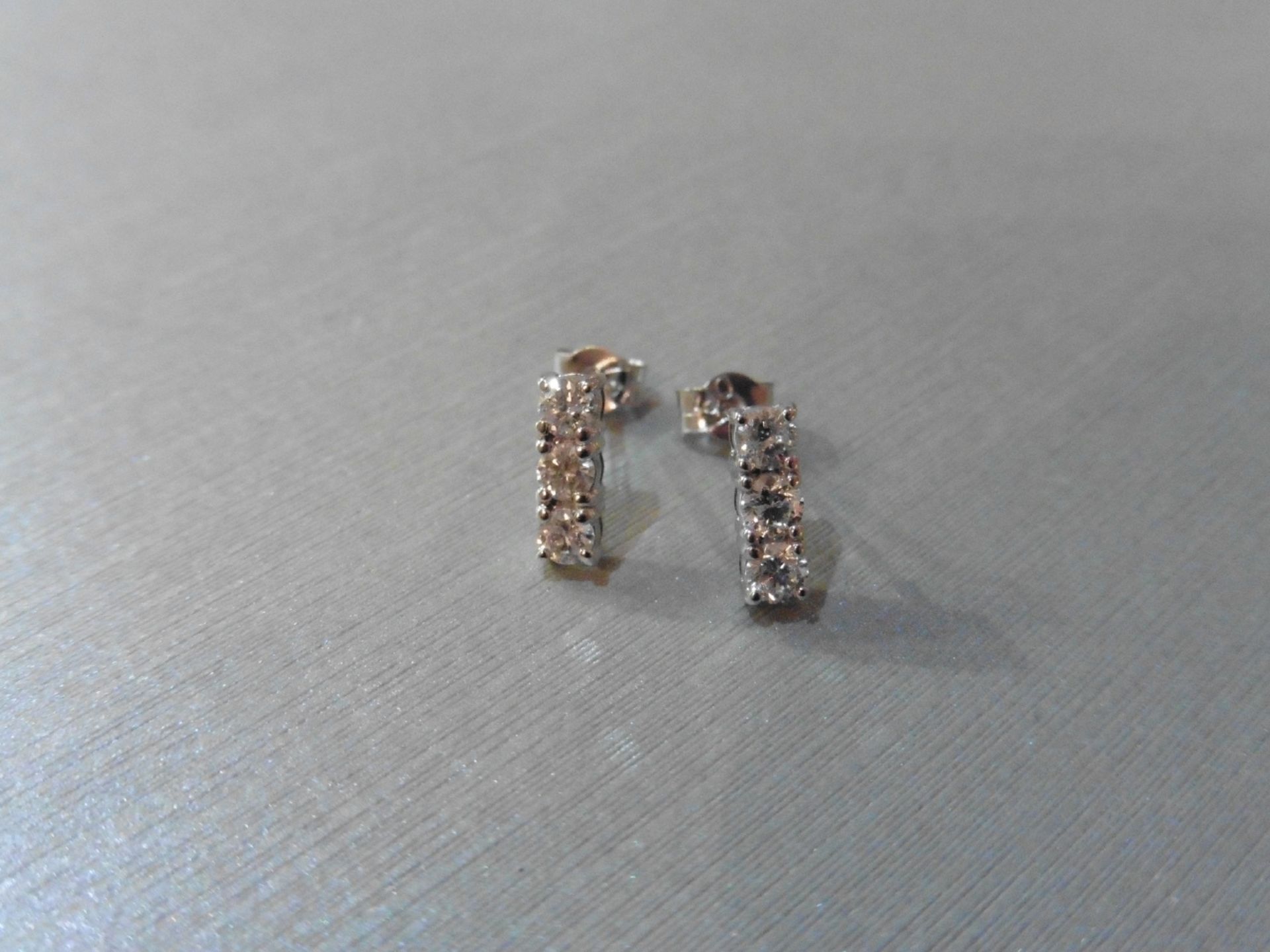 0.60ct trilogy drop earrings set in 18ct white gold.Brilliant cut diamonds, I colour and Si2-3