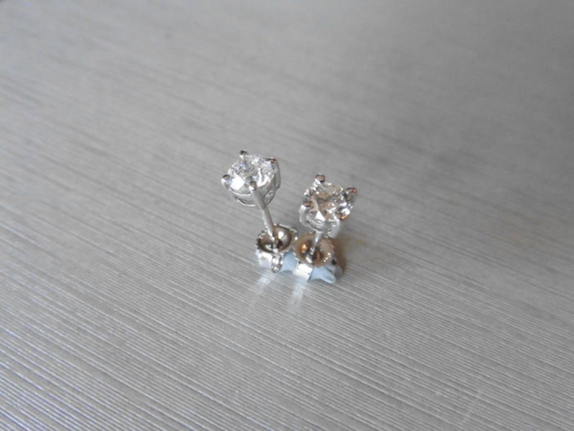 0.30ct Solitaire diamond stud earrings set with brilliant cut diamonds, i1 clarity and I colour. Set