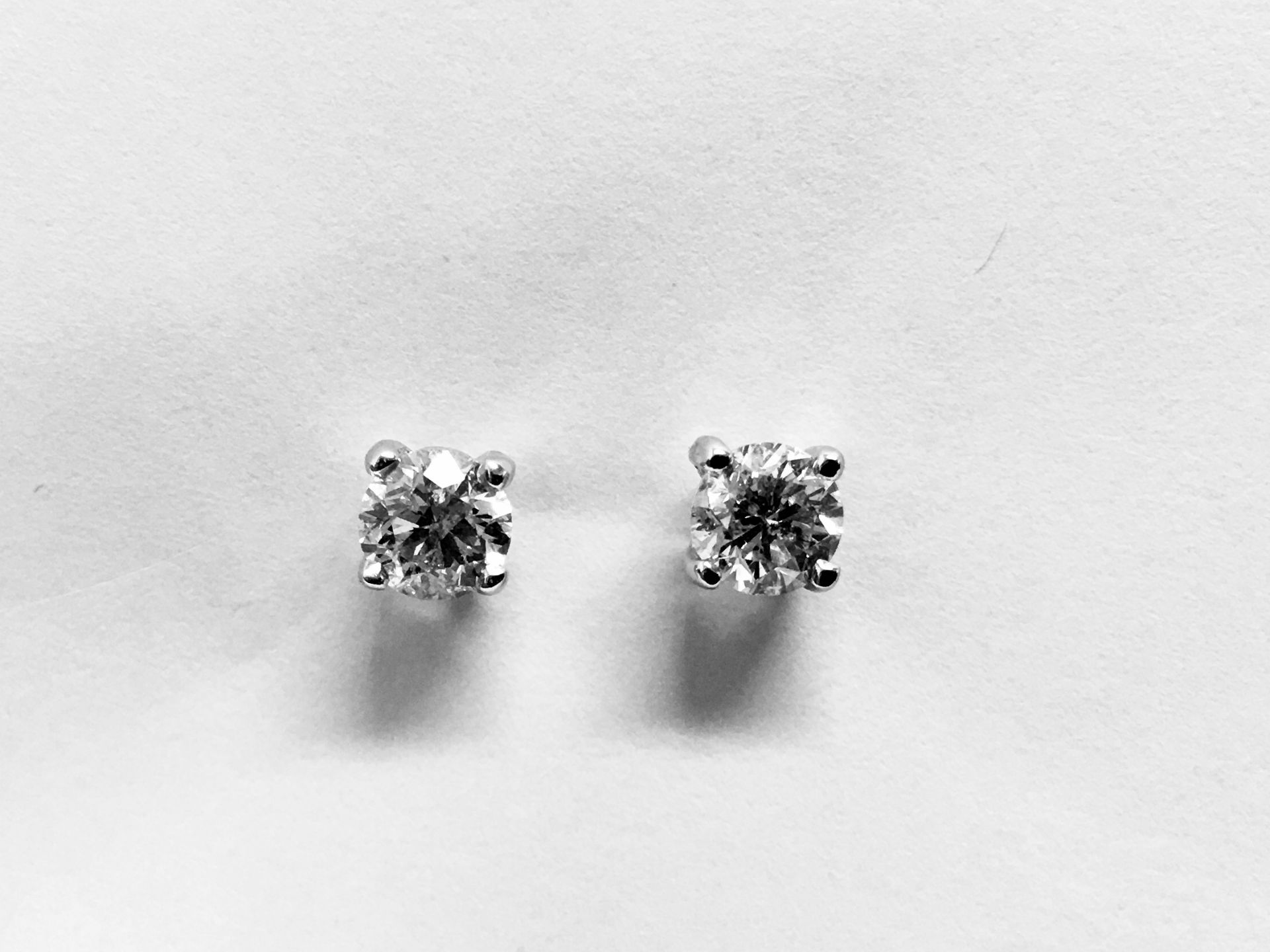 0.66ct Solitaire diamond stud earrings set with brilliant cut diamonds, i1 clarity and I colour. Set