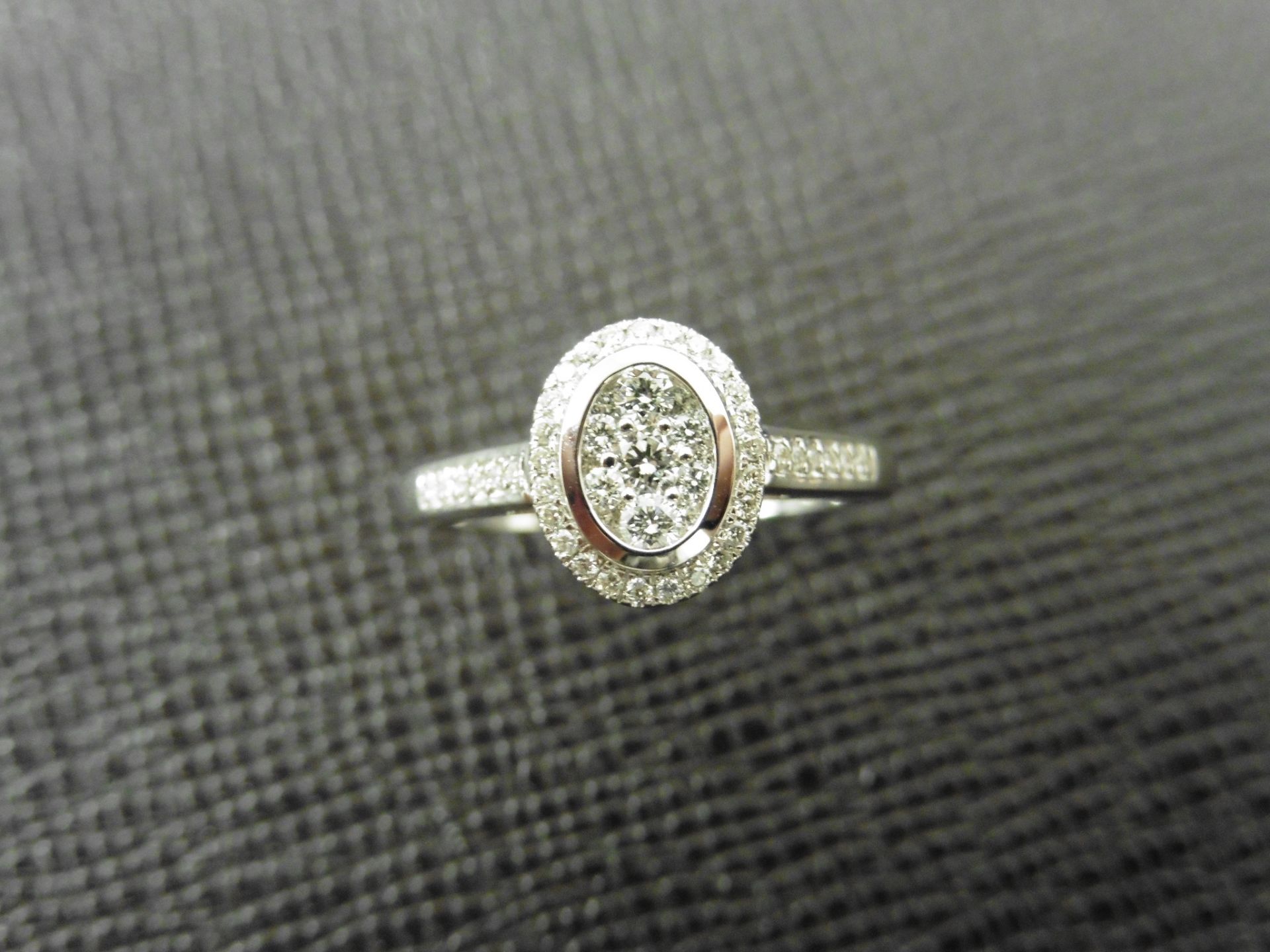 0.33ct diamond set solitaire style ring. Oval setting with small round cut diamonds, H colour and I1 - Image 4 of 4