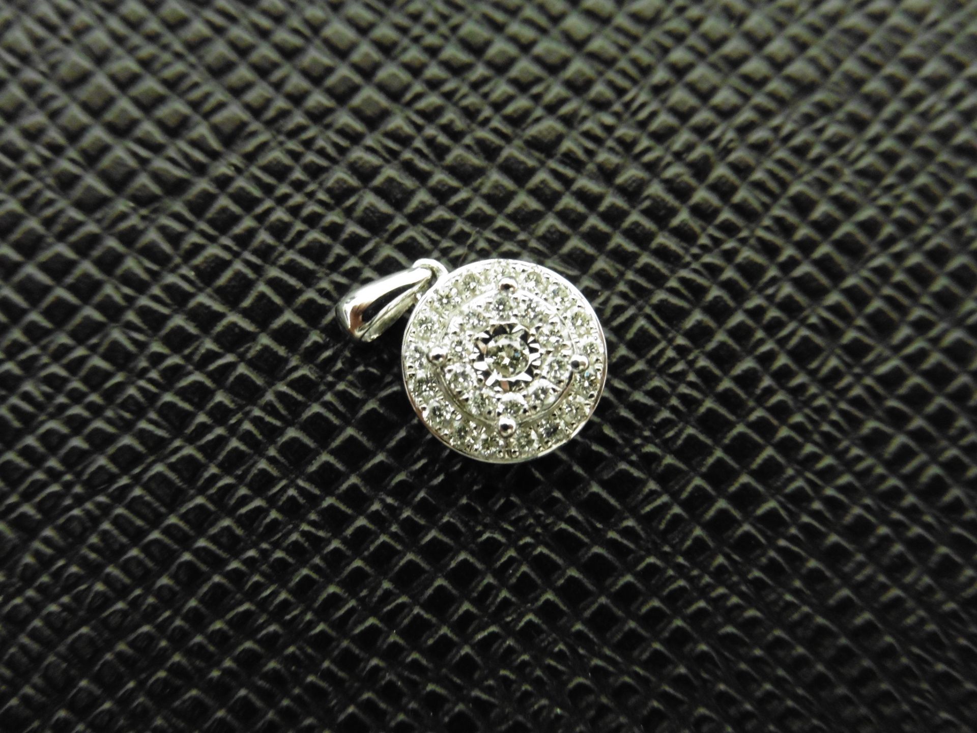 0.24ct illusion set diamond pendant in 9ct white gold. Small round cut diamonds, H colour and I1