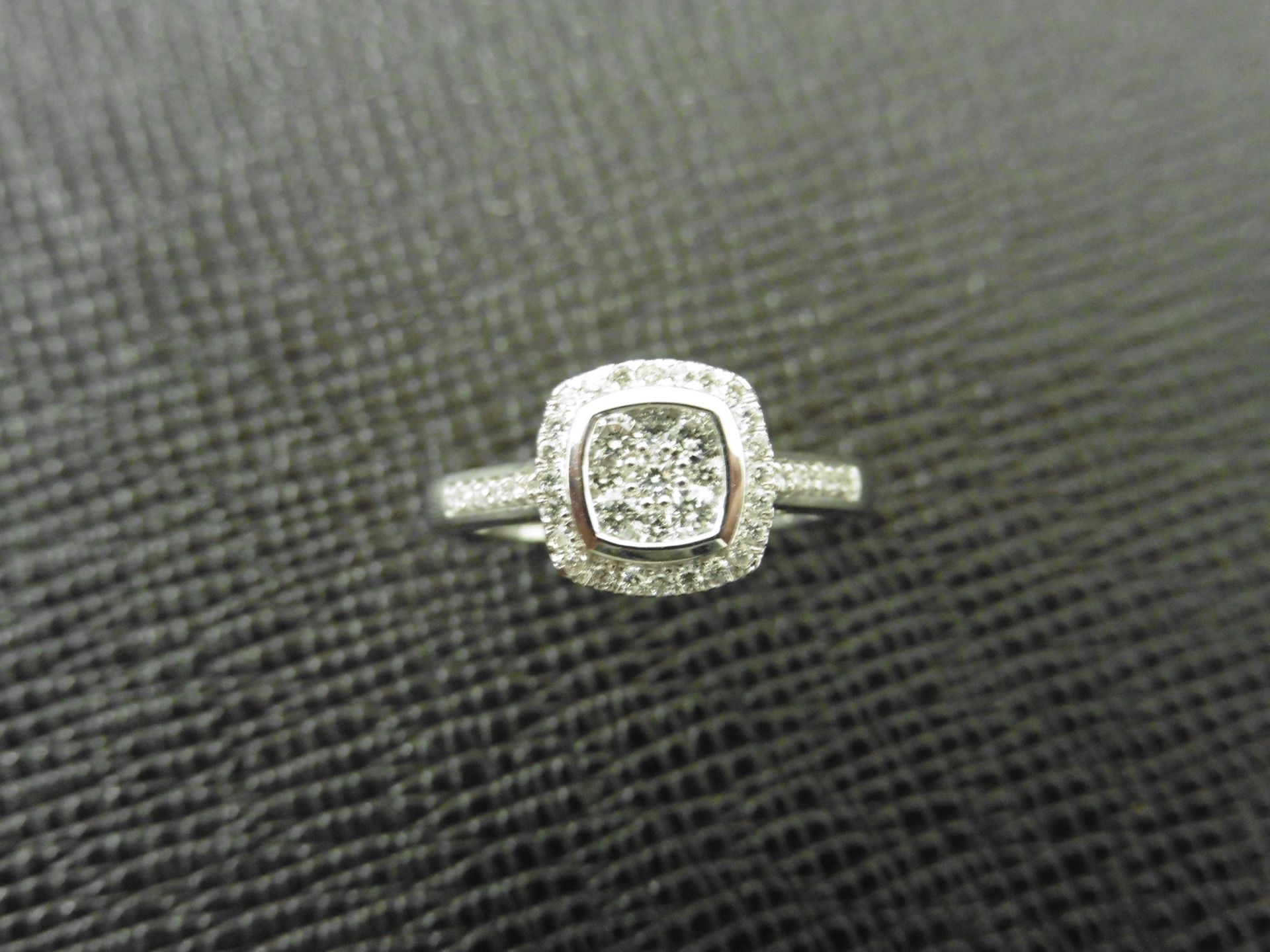 0.33ct diamond set solitaire style ring. Cushion cut setting with small round cut diamonds, H colour