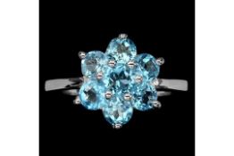 A Beautiful Natural Swiss Blue Topaz Ring, set with 7 Round cut African Blue Topaz - Size M.