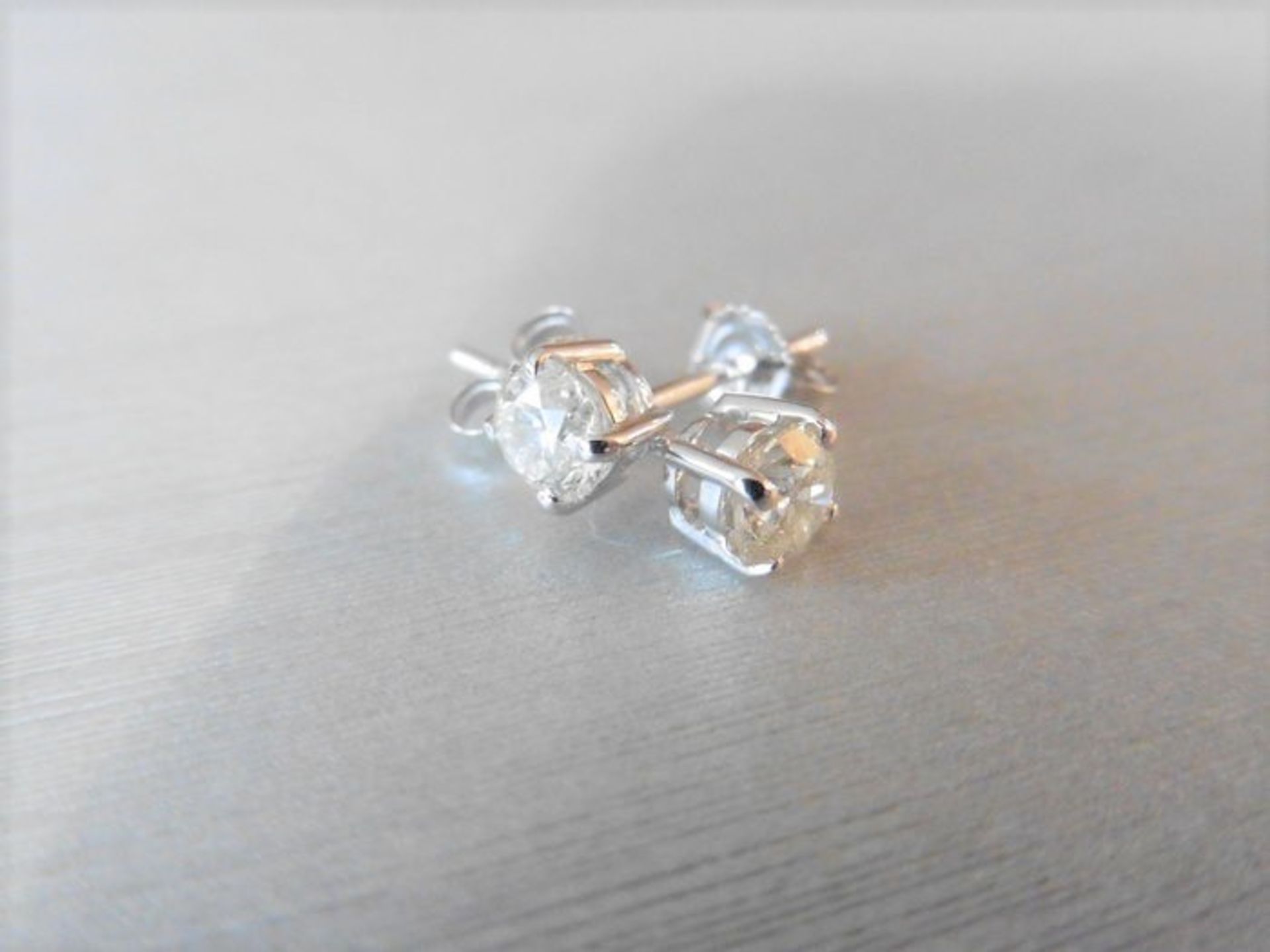 1.90ct Diamond solitaire earrings set with brilliant cut diamonds, I colour I1 clarity. Four claw