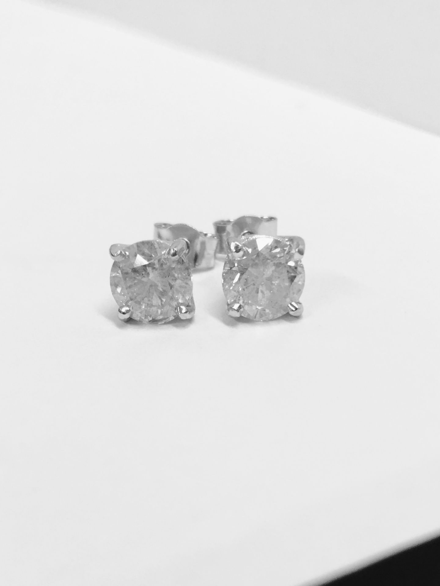 2.00ct Solitaire diamond stud earrings set with brilliant cut diamonds which have been enhanced. H/I
