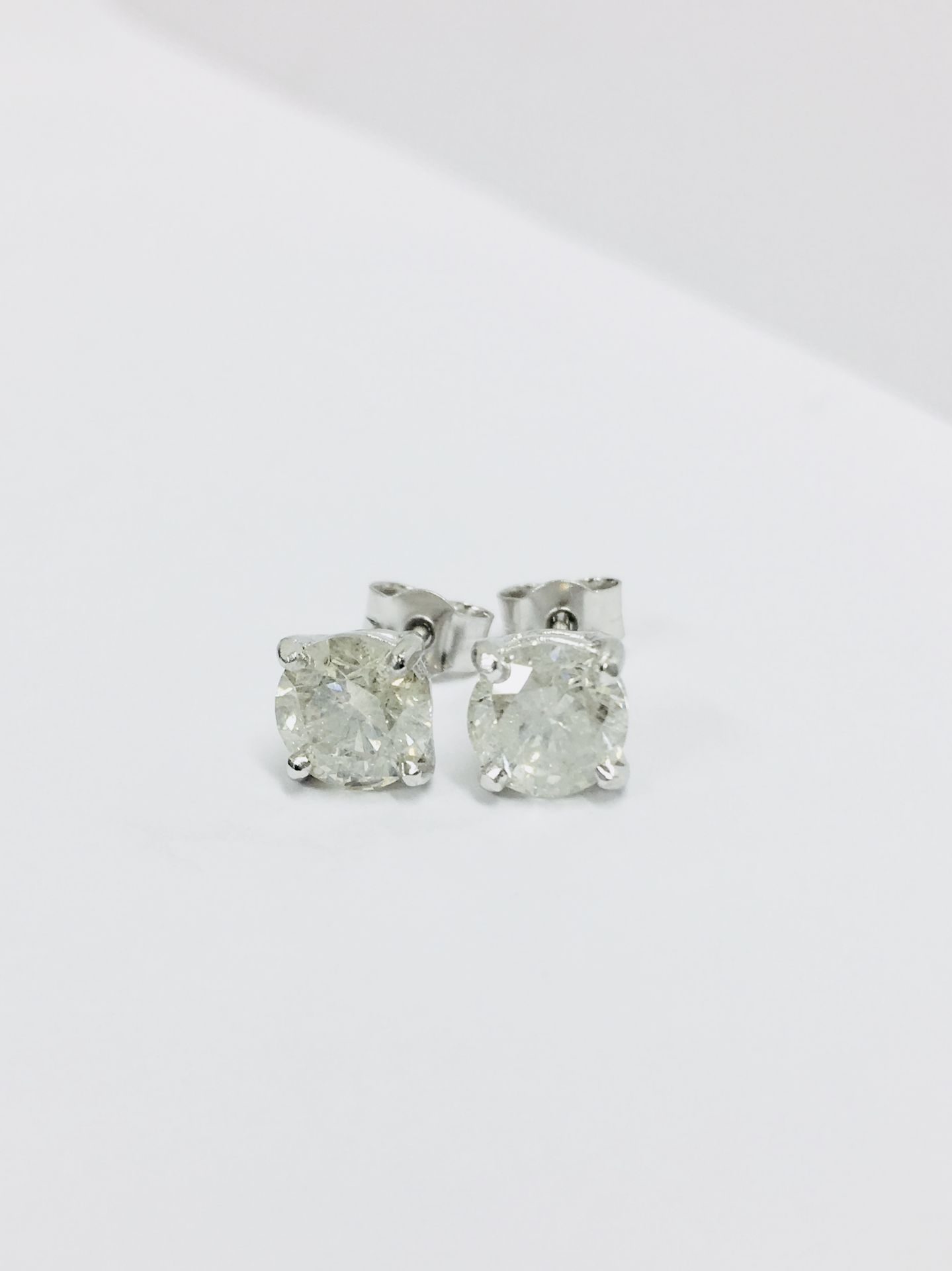 2.00ct Solitaire diamond stud earrings set with brilliant cut diamonds which have been enhanced. J - Image 2 of 4