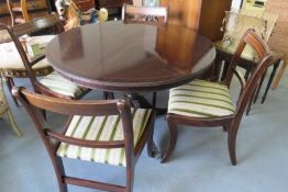 Edwardian inlaid dining table and chairs with claw feet and castors