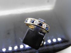 Sapphire and diamond eternity band ring set in 9ct yellow gold. 4 small round cut sapphires (