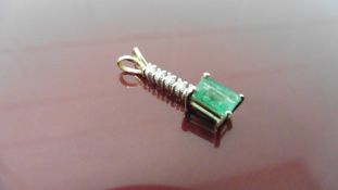 Emerald and diamond drop style pedant. Set with an rectangular cut emerald, 6x4mm, weighing