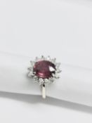 2.50ct Ruby and diamond cluster ring set with an oval cut ( glass filled )ruby which is surrounded