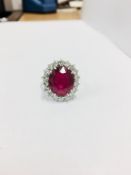 10ct ruby and diamond cluster ring. Oval cut ruby( glass filled) in the centre surrounded by