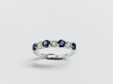 Sapphire and diamond eternity style band ring with 4round cut sapphires and 3 brilliant cut