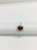 0.80ct Ruby and diamond cluster ring set with a oval cut(glass filled) ruby which is surrounded by