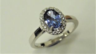 Tanzanite and Diamond cluster ring set in platinum. Oval cut tanzanite ( treated ) 1ct, surrounded