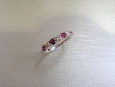 Ruby and diamond eternity band ring set in platinum. 4 round cut ( treated ) rubies and 3
