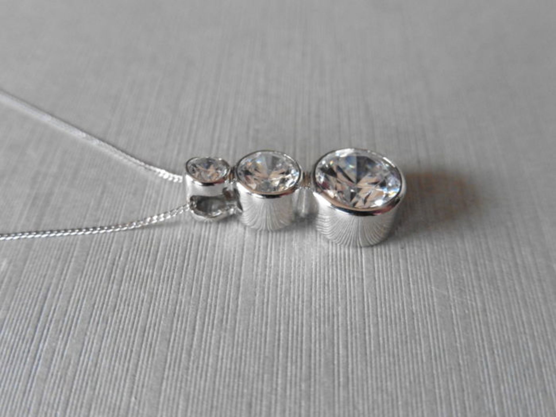 0.80ct trilogy diamond pendant set in platinum. 3 graduated brilliant cut diamonds, I/J colour, - Image 2 of 3