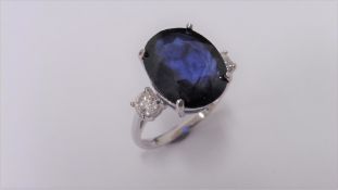 9ct sapphire and diamond trilogy ring set in platinum. Oval cut sapphire ( fracture filled ) with