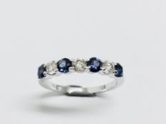 Sapphire and diamond eternity style ring. 4 round cut sapphires ( treated) 3 brilliant cut diamonds.