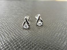 0.10ct diamond tear drop earrings set in platinum 950. 2 small brilliant cut diamonds, H colourand