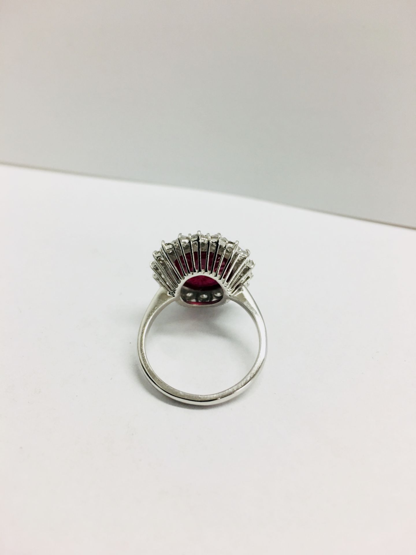 6ct ruby and diamond cluster ring set in platinum. Oval cut colour treated ( fracture filled ) - Image 4 of 6