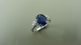 2.50ct sapphire and diamond dress ring. 9x7 oval cut ( glass filled ) with 3 small brilliant cut