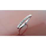 0.13ct diamond band ring set in 14ct white gold. Small brilliant cut diamonds, I colour and i1