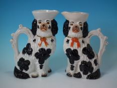 Pair Staffordshire Pottery black and white spaniel pitchers