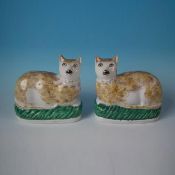 Pair of Rare Staffordshire pottery cats, recumbent on cushions